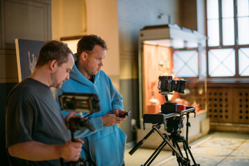 The director of photography with a camera on the set. A professional videographer is working on...