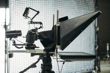 Professional film and video cameras on the set. Filming crew, lighting equipment, professional filming equipment and crew. Methods of modern film production and advertising.