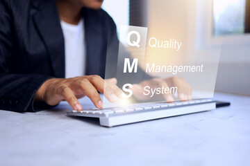 Quality management system concept with businessman working on desktop with computer to manage the...
