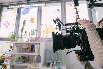 Professional film and video cameras on the set. Filming crew, lighting equipment, professional filming equipment and crew. Methods of modern film production and advertising.