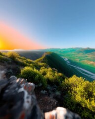 Valley Silhouette at Sunset: Lush Green Hills Against a Pale Sky
