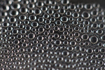 Macro World of Condensation: A captivating macro shot revealing a mesmerizing network of tiny water...