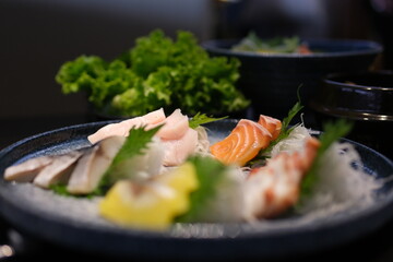 Delicate slices of fresh salmon sashimi are artfully arranged on an elegant plate, garnished with herbs and edible flowers, embodying fine dining. High quality photo