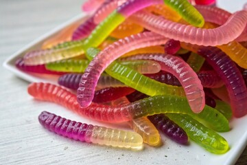 Colorful gummy worms candy on white background
A pile of vibrant gummy worms in assorted colors and flavors on a white surface, highlighting playful, sweet, and fun treats.
