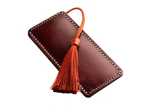 Brown leather bookmark with orange tassel isolated on transparent background