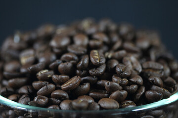Roasted Coffee Beans: A close-up view of a rich, aromatic pile of roasted coffee beans, perfect for your morning brew, showing their inviting dark texture.