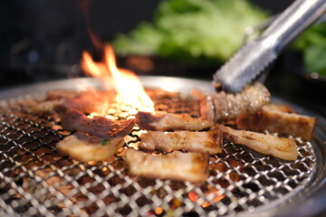 Man grilling burgers, sausages, and vegetables on a charcoal kettle grill during golden hour. Perfect for summer BBQ, outdoor cooking, and food themes. High quality photo