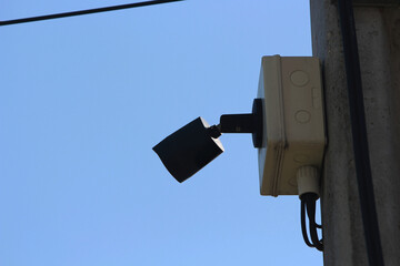 Security Camera on Pole: A vigilant security camera, mounted on a sturdy pole, oversees a scene, its lens capturing every detail.