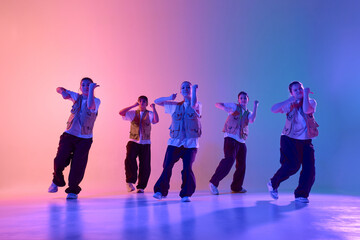 Youthful energy vibrant urban dance crew consisting of diverse teenagers performs creative...