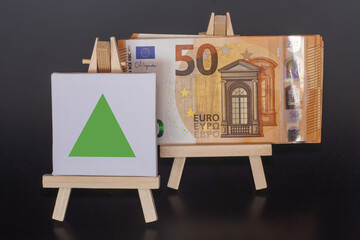 50 Euro Banknote and Geen Arrow Sign on Miniature Easels – Financial Concept