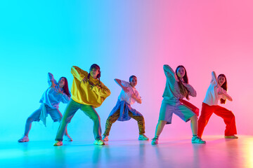 Youthful dancers in vibrant attire perform against a multicolored urban backdrop, highlighting creative movement and modern culture. Concept of contemporary youth empowerment.