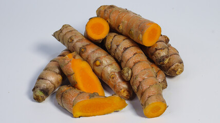 Turmeric Roots: Fresh turmeric roots, sliced and whole, showcase the vibrant orange hue and earthy textures of this culinary and health staple.