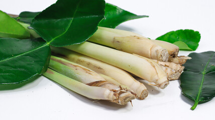 Aromatic Lemongrass and Lime Leaves: An inviting arrangement of fresh lemongrass stalks and vibrant lime leaves, creating an image bursting with refreshing flavors, perfect for culinary enthusiasts.