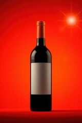 Fototapeta premium Bottle of red wine against vibrant red background with blank label, ready for personalized branding.