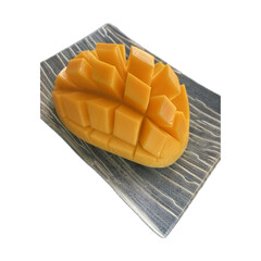 A single ripe mango, expertly sliced in a 'hedgehog' style (mango igel), with the golden-yellow flesh cross-hatched and fanned out, resting on a dark, possibly slate or ceramic