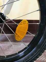 Urban bike wheel resting on tiled floor in indoor setting