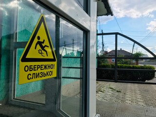 Caution sign warning of slippery surface in urban area