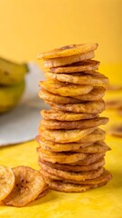 Stacked Fried Plantain Chips on Yellow Background – Crispy Tropical Snack Food Concept.