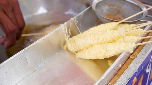 Telur Gulung is street food from indonesia that is made from eggs that mixed with bihun (rice noodles) and rolled with a skewers.