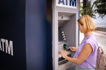 Summer banking at an ATM in beautiful Greece