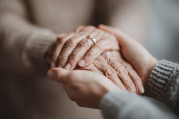 A touching moment of an elderly woman and her caregiver sharing a warm connection while walking.