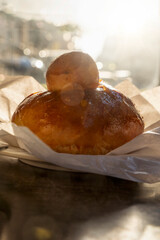 Sicilian brioche with tuppo in golden morning light on cafe table