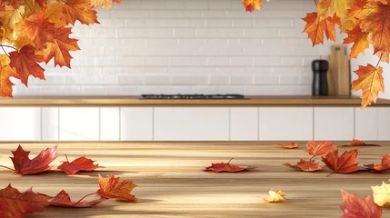 Schilderijen op glas Autumn leaves scattered on wooden kitchen countertop with blurred white tile background, creating warm seasonal kitchen decor ambiance © Maria Mikhaylichenko