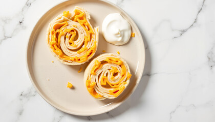 Rolled pancake dessert with mango filling and cream on marble plate  