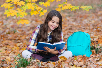 School girl reading book outdoor. Teen girl reading in the autumn park. Education and knowledge. Knowledge day. Self education. Autumn book. Back to school. School education. Reading poem
