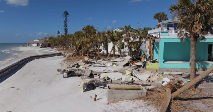 Ruined building in need of demolition or repair. Storm surge water and wind damaged house roof and collapsed walls after hurricane in Florida.