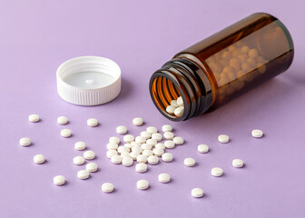 Spilled Pills: a scattering of round, white pills have spilled from an amber glass bottle with white cap onto a delicate lilac surface.