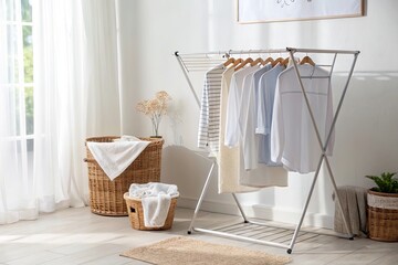 Freshly laundered clothes hanging on a drying rack in a sunlit room with woven baskets