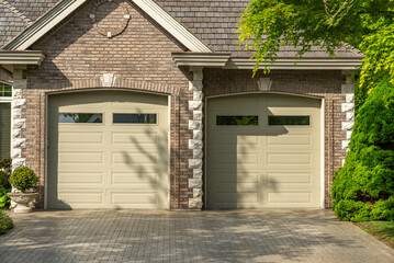 Garage door in luxury house with trees and nice landscape in Spring in Vancouver, Canada, North...
