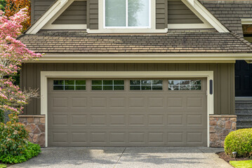 Garage door in luxury house with trees and nice landscape in Spring in Vancouver, Canada, North...