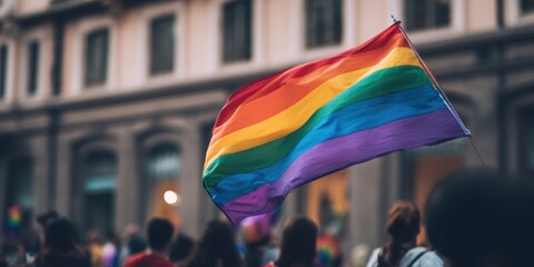 The vibrant rainbow flag waving at a lively pride celebration in the city.