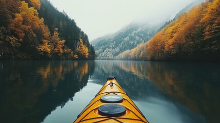Kayak floats over the lake with autumnal trees lining the mountains