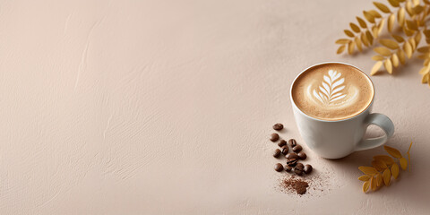 Latte Art Delight: A beautifully crafted latte, adorned with delicate art, sits invitingly alongside coffee beans and a sprig of autumnal leaves on a neutral surface.