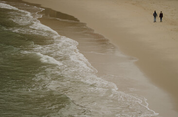 Couple walking on the beach. Cat Co 3 Beach. Cat Ba Island. Cat Ba Archipelago. Vietnam.