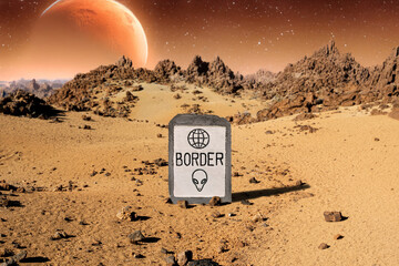 A boundary milestone with entity symbols on an inhospitable planet