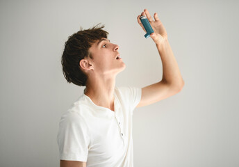 teen having an asthma problem in studio gray