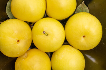 Bright yellow plums, top view, macro.