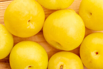 Bright yellow plums, top view, macro.