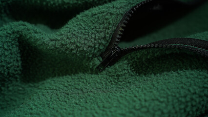 Close-Up of Green Fleece Fabric with Black Zipper