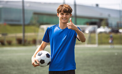 motivation soccer player with a football in a sport uniform