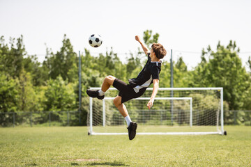 motivation soccer player with a football in a sport uniform