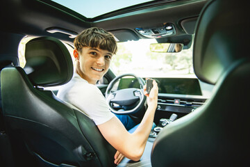 teen girl driver on car on summer day