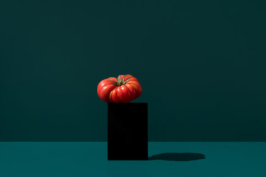 Raf tomato on a dark green background