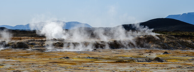 Stunning geothermal landscape in Iceland with steam vents and rugged terrain