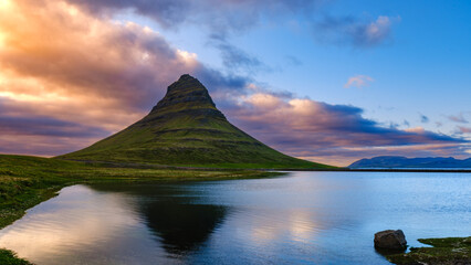 Majestic Kirkjufell Mountain reflected in tranquil waters at sunset in Iceland
