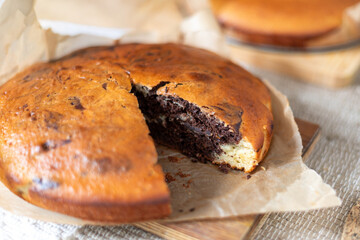 Delicious homemade marbled cake displayed on parchment paper. The swirled chocolate pattern adds a...